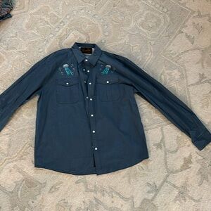 Blue Howler Bros button down polo with jellyfish design and dual pockets